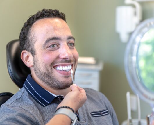 Smiling patient seating on patients chair